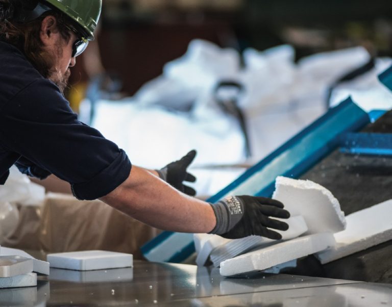 An Agilyx employee handling polystyrene waste.