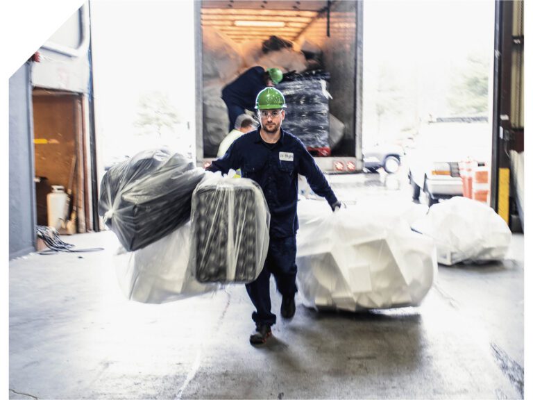 An Agilyx employee carrying polystyrene waste.
